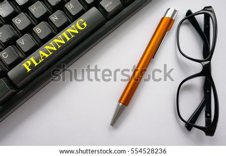 Equipment such as computer keyboard, a pen and eyeglasses isolated on a white background with a wording for an office used.