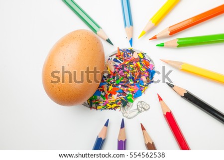 Wooden colorful pencils with sharpening shavings, on white color background; There are eggs in the picture