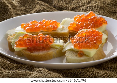 Red caviar with butter and baked bread. Close-up. Side view