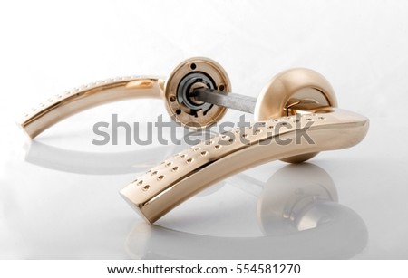 Golden door handle isolated on a white background