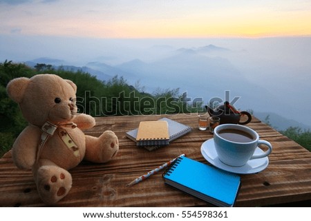 Teddy bear coffee background blur sunset on the horizon.