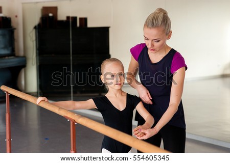 Coach teaches girl Ballet