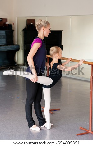 Coach teaches girl Ballet