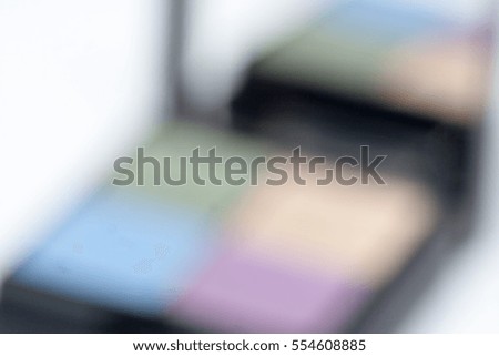 Blurred background and textures. Eye shadow set. Beauty and fashion background. 