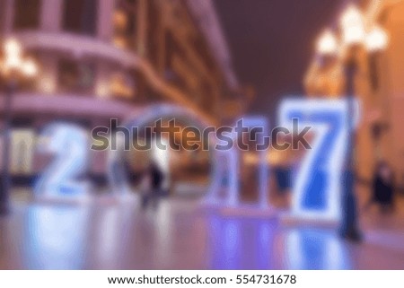 Blurred image bokeh of People walking around city of Moscow, Russia. With 2017 sign, Christmas lighting and decoration at night.