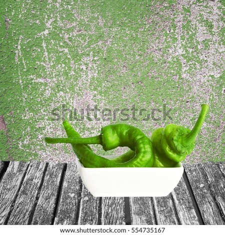 Green chili in white bowl on wooden table. Copy space.	Pantone greenery year color trend