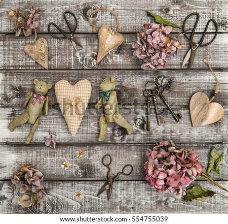 Vintage toys, hortensia flowers and wooden hearts. Nostalgic flat lay. Retro style still life