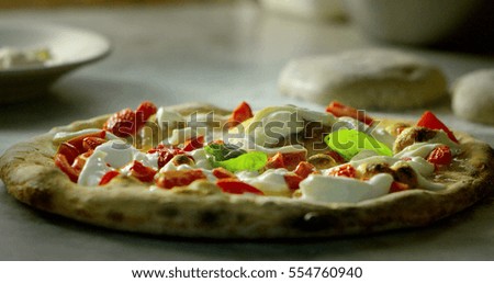 high quality pizza typical Italian food with Italian mozzarella cheese and fresh tomato sauce freshly harvested, with a fragrant basil leaf.Concept of: italian food, italy, restaurants and tradition.