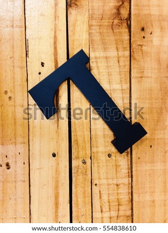Letter L isolated over wooden background