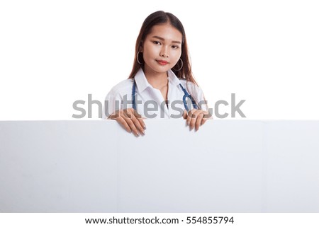 Young Asian female doctor show thumbs up  behind blank white billboard isolated on white background.