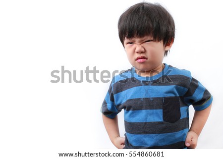 Stubborn, sad, upset little Asian boy isolated over white background.Facial expression. Royalty-Free Stock Photo #554860681
