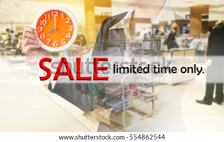 Sale limited time only, and business woman holding clock on blurred shopping mall. Business concept.