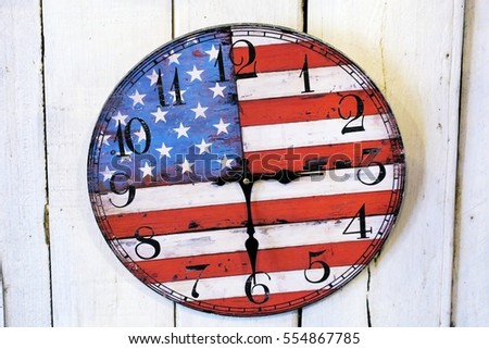 Clock face with american flag on wall. USA vintage wall clock decoration on wooden background