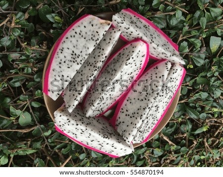 Slice of dragon fruits are on a plate background.
