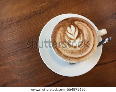 a cup of hot chocolate in a white mug on wooden table