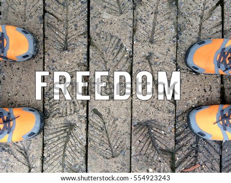 Top View of Sneaker Shoes on the floor with text freedom written on background