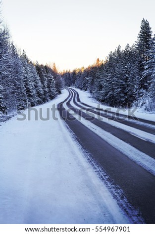 Snowy winter road in the cold winter day. Image has a vintage effect applied.