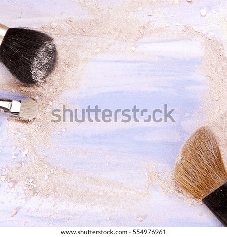 Makeup brushes on a light purple background, with traces of powder and blush on it. A square template for a makeup artist's business card or flyer design, with plenty of copyspace