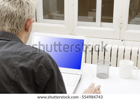 modern young man with the laptop at home or in the office