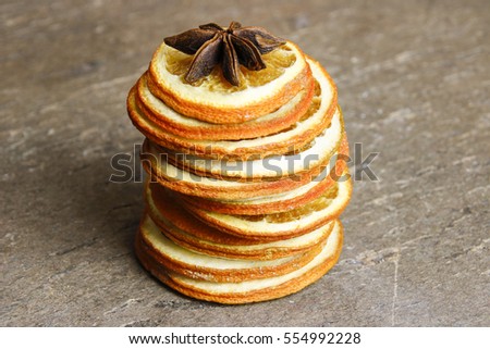Dried slices of orange on a brown wooden surface