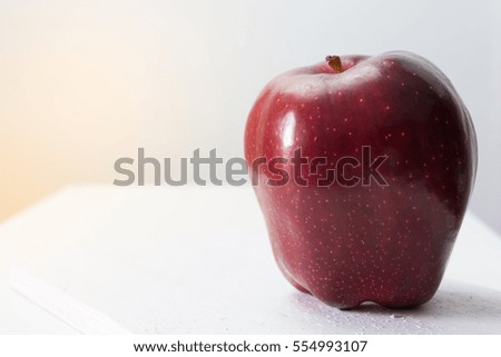 single red apple on table white background