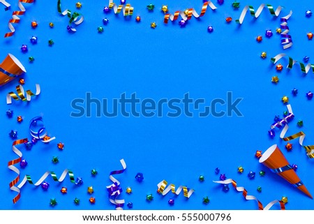 top view of framed party accessories on blue background