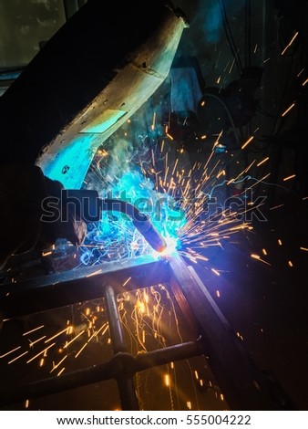 welder, welding, blacksmith welding a gate Royalty-Free Stock Photo #555004222