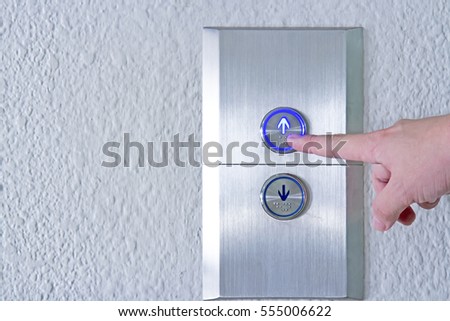 Using hands, press the elevator up and keypad elevator
