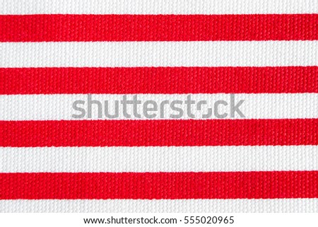 Textile background with red and white stripes. Fabric texture