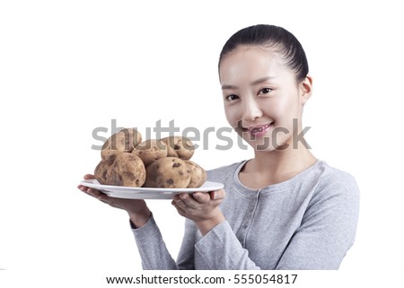 	young woman holds a plate of potatoes	