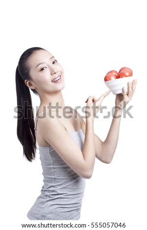 	young woman holds a bowl of tomatoes	