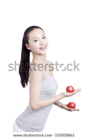 	young woman holds two tomatoes	