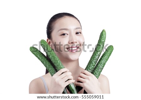 	young woman holds cucumbers in her hands	