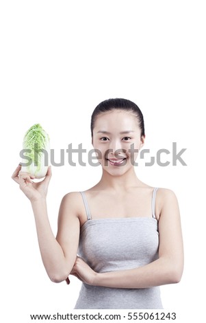	young woman holds Chinese cabbage in her hand	