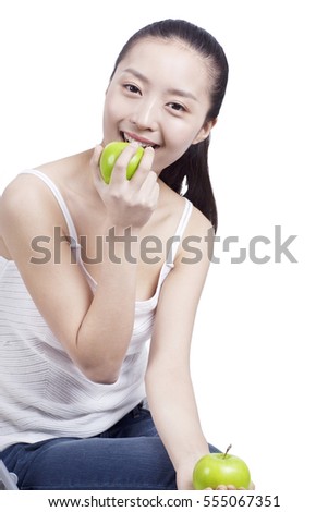 	young woman holds two green apples in her hands	