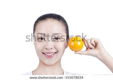 	young woman with an orange in her hand	