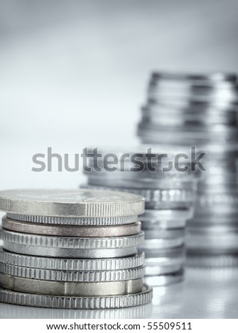 stacks of money coins , blue toned closeup photo with shallow DOF, useful for various money or economy themes