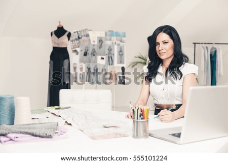 Fashion designer making sketches at her office.