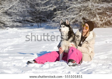 Girl with her cute dog Husky on a walk