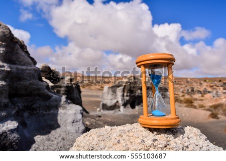 Conceptual Photo Picture of an Hourglass Object in the Dry Desert