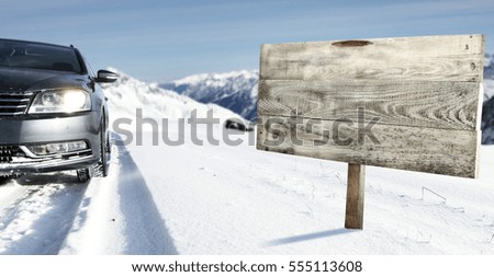 Free space for your decoration on road sign and car on winter road 