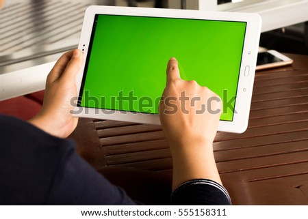 Women touch tablet green screen concept technology. 