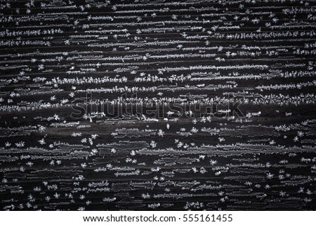 Dark old wood with hoarfrost. Old wooden background with winter cold ice.