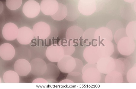 Soft colorful bokeh background. Luminous garlands of electric lights. Copy space to add text. Saturated colors. Blurry abstraction. Gentle pink, brown tone. Dark night. Festive party.