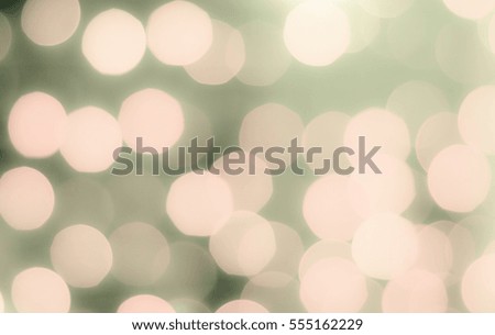 Soft colorful bokeh background. Luminous garlands of electric lights. Copy space to add text. Saturated colors. Blurry abstraction. Gentle brown, orange, green tone. Dark night. Festive party.