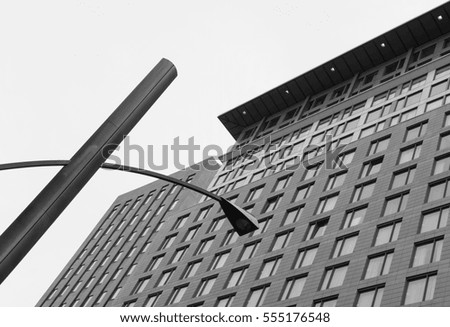 Abstract view of a modern hotel and office block together with a new generation streetlamp in the picture.