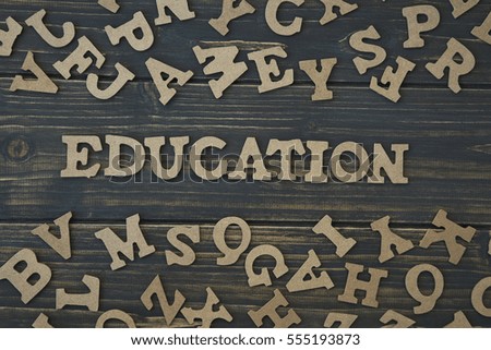 Word education on a dark wooden background