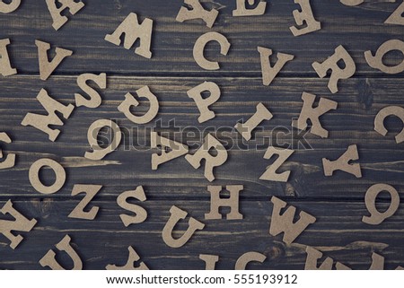 Letters on a wooden brown background