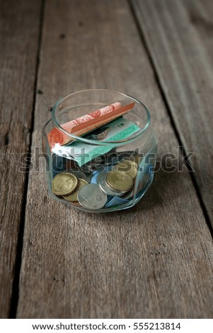 Money saving in the glass bottle for money concept