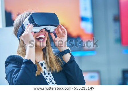 Young woman wearing virtual reality device Royalty-Free Stock Photo #555215149
